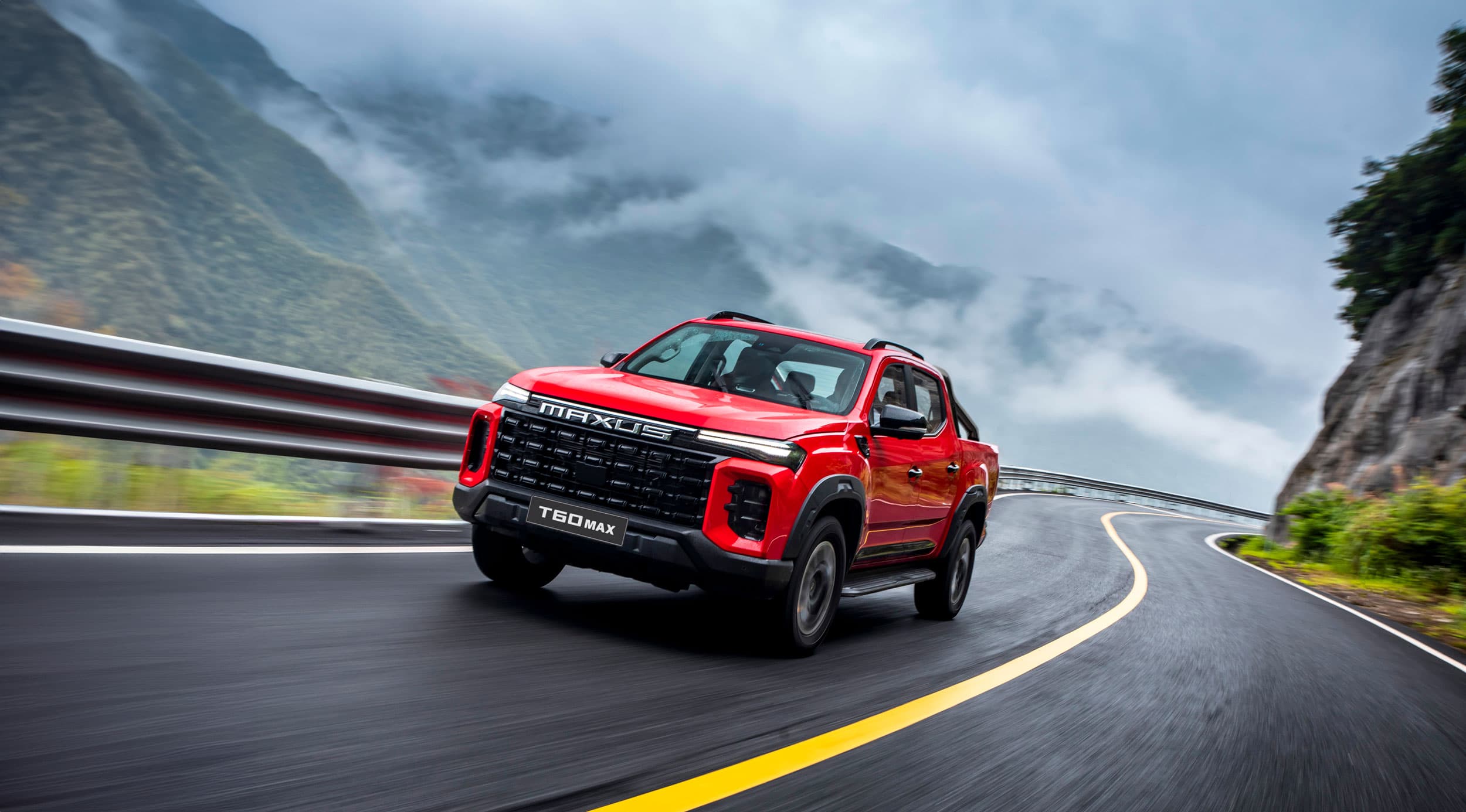 Maxus T60 Max driving on a road in the clouds (chinese red)