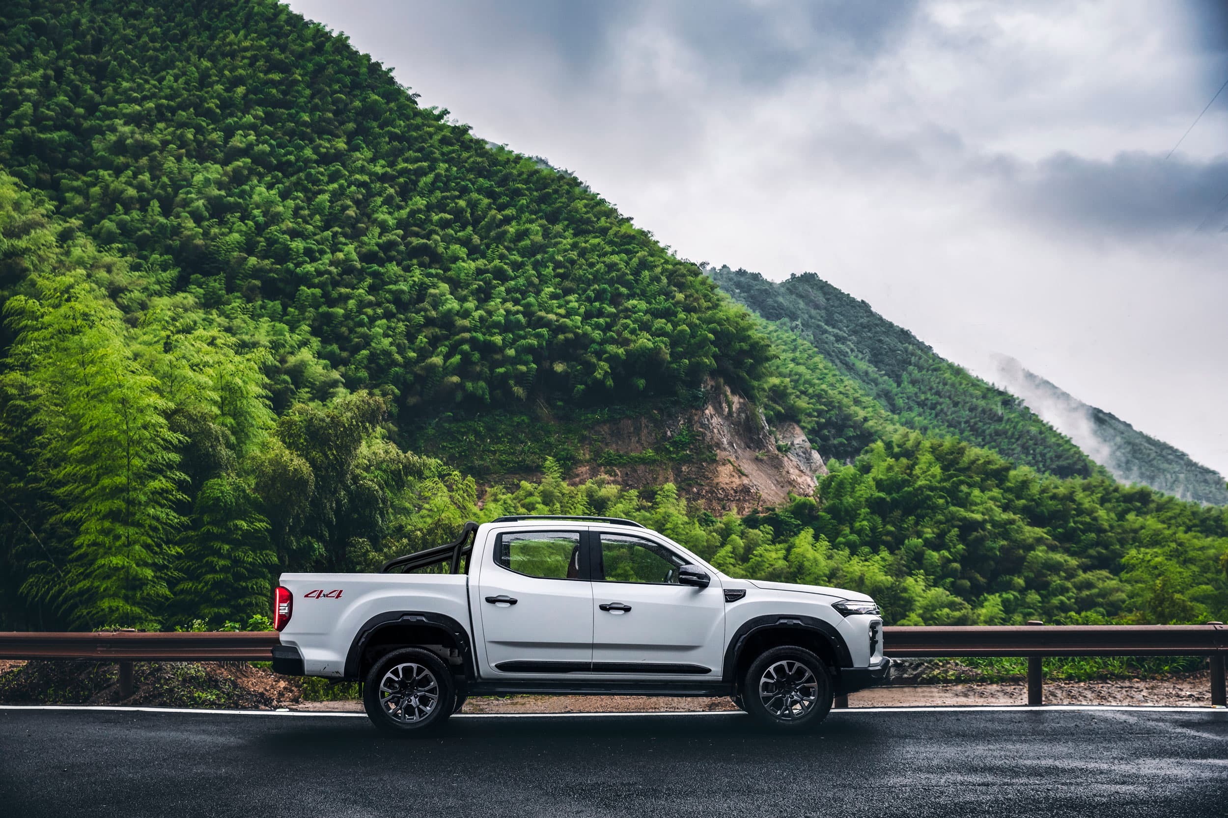 Maxus T60 Max parked in the mountains sideview (warm white)