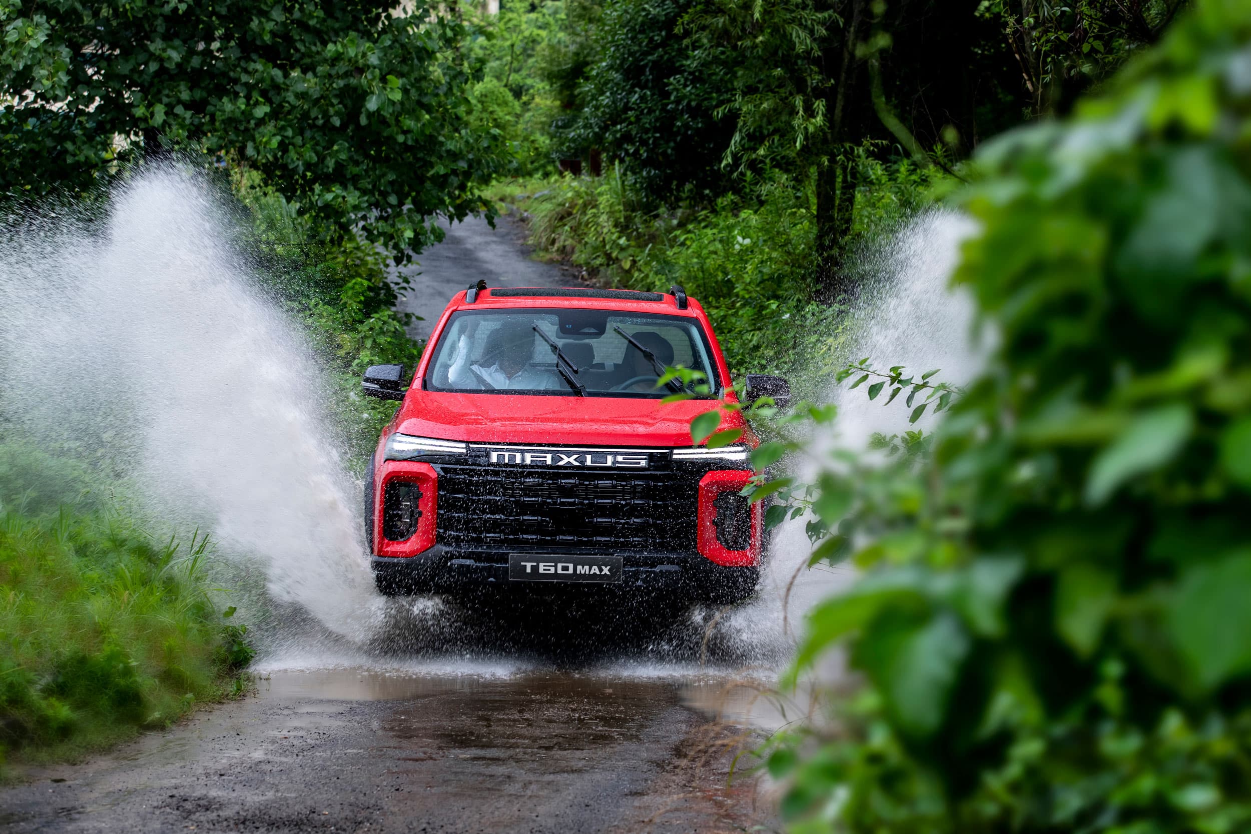 Maxus T60 Max driving through splashing water (chinese red)
